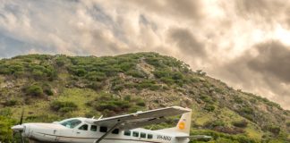 aircraft on a grass strip in front of a hill