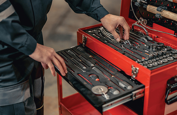 image of an engineer handling various instruments and tools