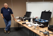 image of Martin Bass beside a table of drones
