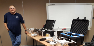 image of Martin Bass beside a table of drones