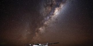A Cessna 208B EX surrounded by the night sky