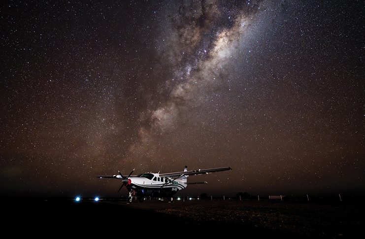 A Cessna 208B EX surrounded by the night sky
