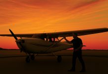 Image of pilot inspecting light aircraft at sunset