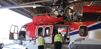 Image of a helicopter being inspected
