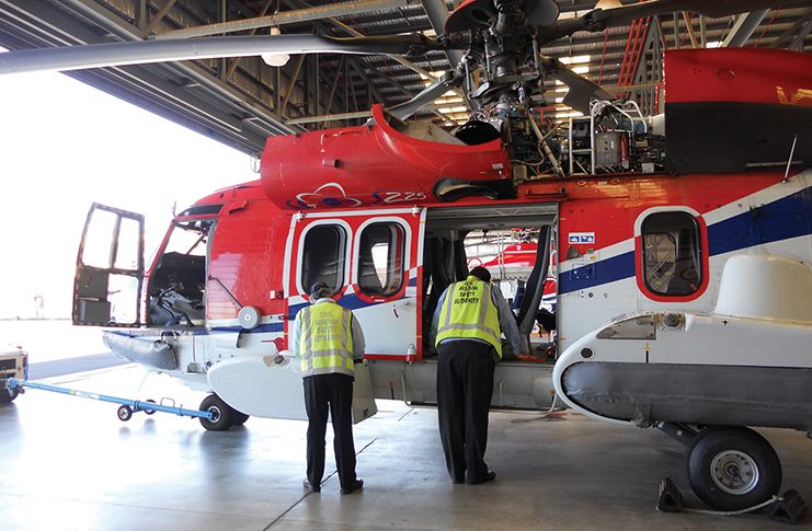 Image of a helicopter being inspected
