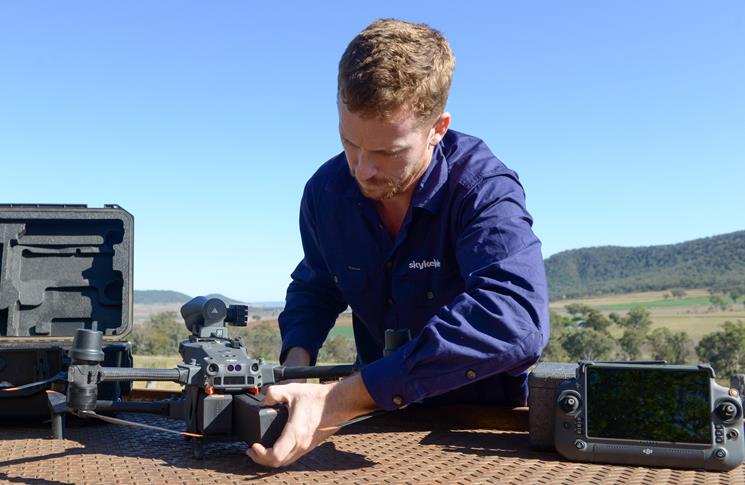 Luke Chaplain making adjustments to his drone and making sure it's safe to fly.