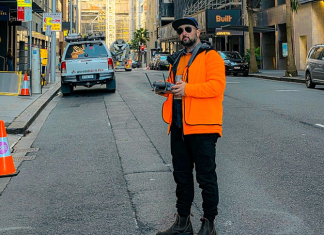 Danny Elassad flying a drone on a city street.