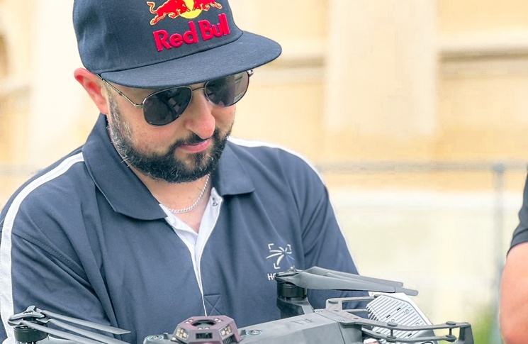Danny Elassad inspecting a drone before flying.