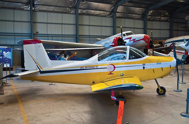 Age must not weary them A yellow and white aeroplane is parked in a hangar.