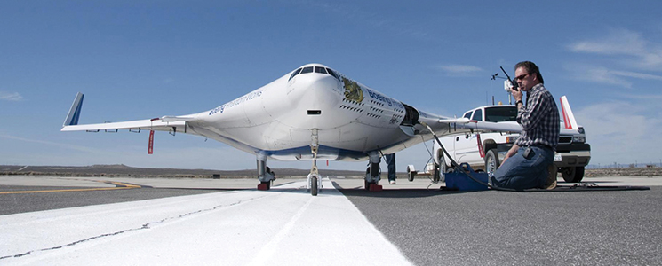 A NASA scientist testing a scale model of a blended wing body aeroplane.
