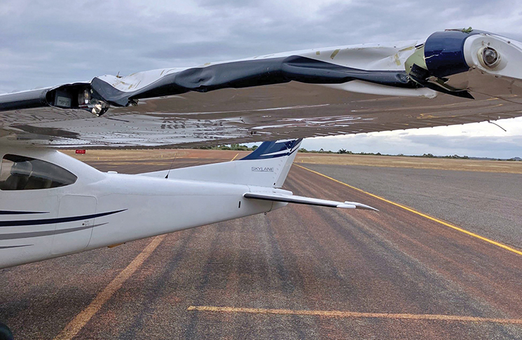 The damaged wing of the Cessna 182T aeroplane in this accident