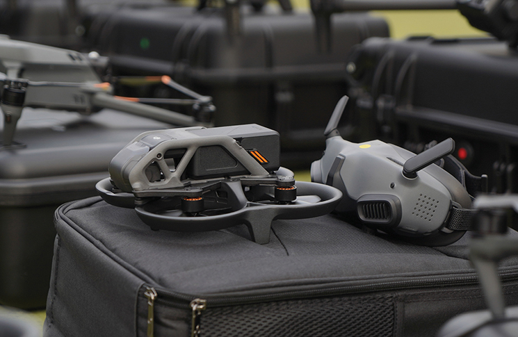 An FPV drone with its goggles sitting on top of its carry case.