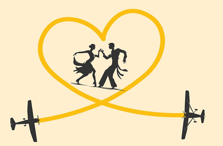 Two people dancing in a yellow heart that shows the paths of two aeroplanes