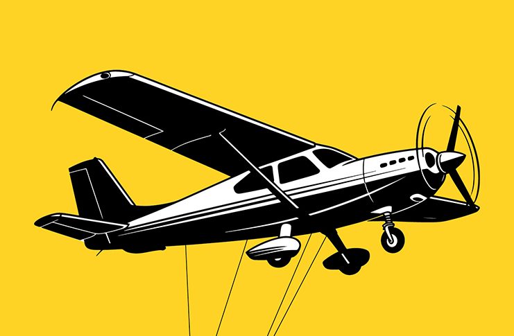 A aeroplane with several cables suspended beneath it