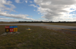 Keeping off runways: preventing runway incursions View of taxiway B and runway 12 at Jandakot Aerodrome, showing a runway holding point sign and the intersection area where pilots must maintain situational awareness while taxiing.