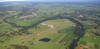 Aerial view of an aerodrome surrounded by green fields