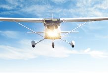 An oncoming aeroplane with blue sky behind it
