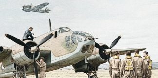 Engineers inspect a Bristol Beaufort as a group of pilots walks towards it