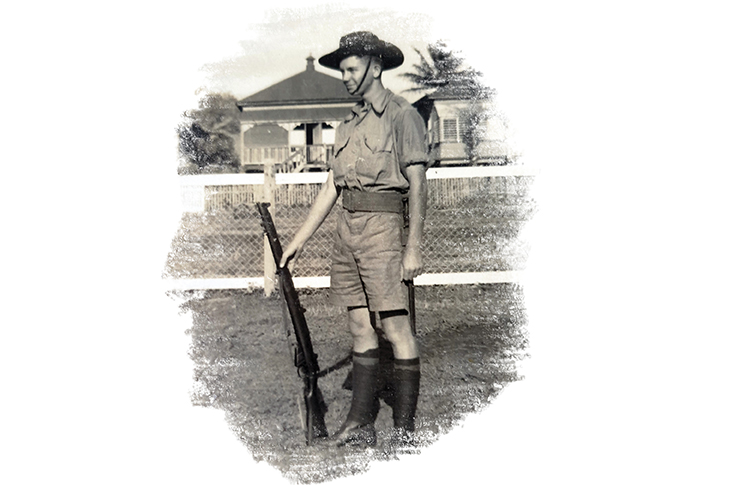 Laurie Smith in uniform and holding a rifle