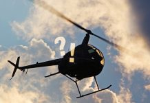 Fancy meeting you here A helicopter flying through the sky, with "?!" superimposed over it