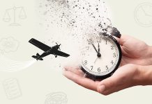 A pair of hands holding a clock disintegrating into particles while a plane flies in the background