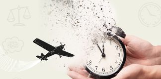 A pair of hands holding a clock disintegrating into particles while a plane flies in the background