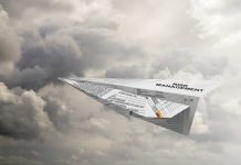 A paper aeroplane made from a risk management form flies through a cloudy sky
