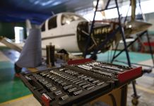 Maintenance quiz: Spring 2026 An open toolbox in a hangar with an aeroplane under maintenance behind it