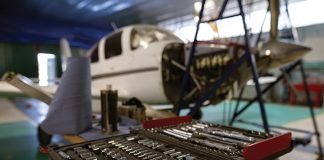 Maintenance quiz: Spring 2026 An open toolbox in a hangar with an aeroplane under maintenance behind it