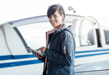 Take your next step in aviation safety Female safety manager holding computer tablet.
