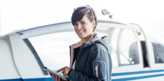 Female safety manager holding computer tablet.